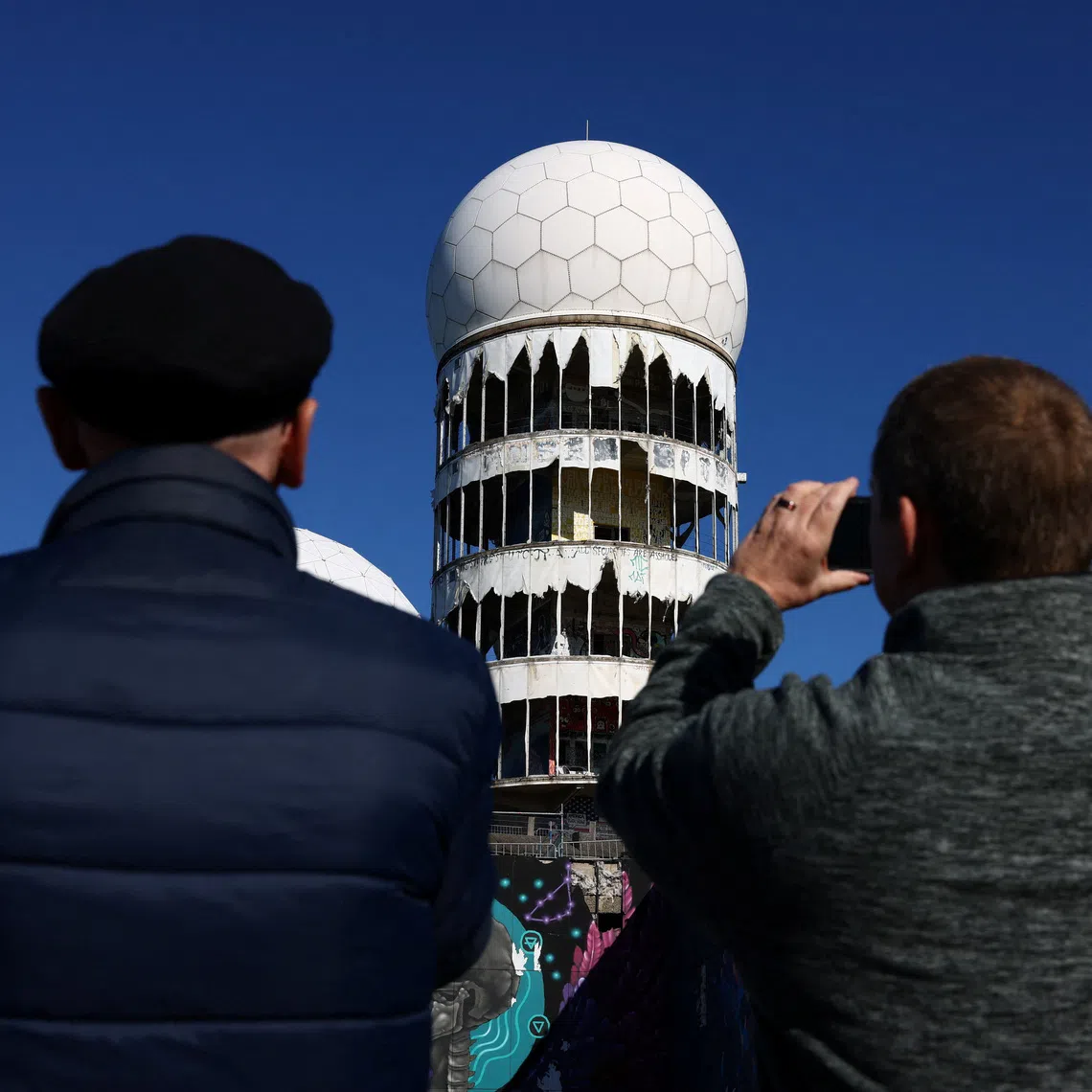 A group of former British conscripts, once stationed at the Teufelsberg U.S. listening and radar station, return to their former post to reminisce about their work in the divided city during the Cold War, in Berlin, Germany, September 24, 2025. REUTERS/Christian Mang