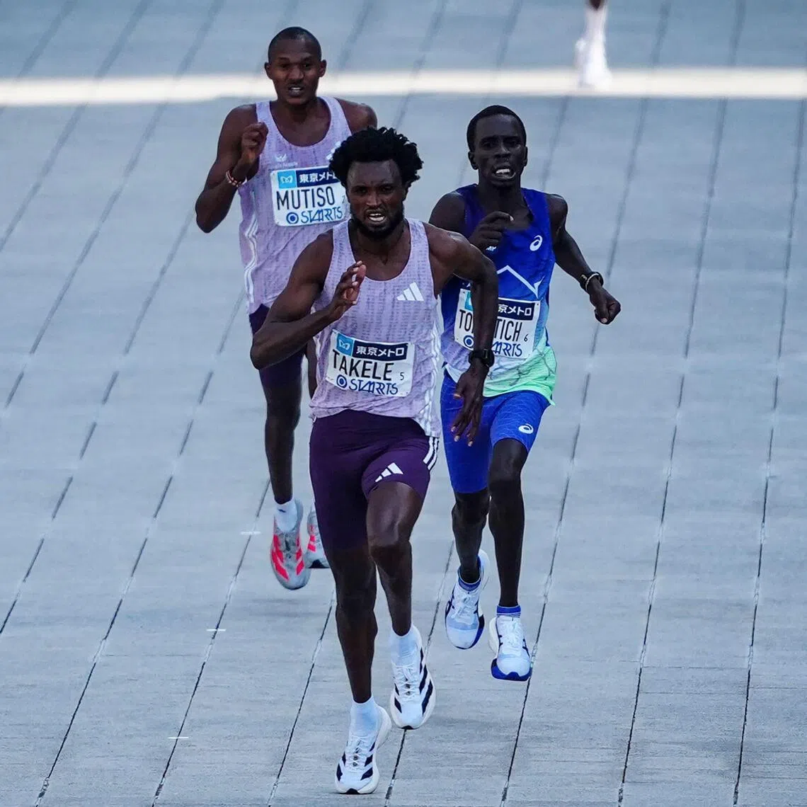 Ethiopia’s Tadese Takele races to the finish line first followed by Kenya’s Geoffrey Toroitich (middle) and Kenya’s Alexander Mutiso (back) in the men's category of the Tokyo Marathon.