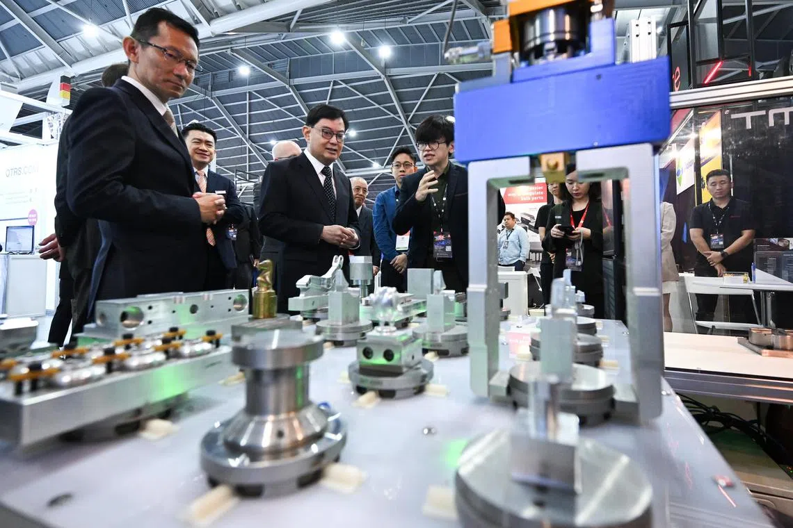 ST20241014-202473000576-Lim Yaohui-Timothy Goh-tgitap/
Mr Allen Xue, (third from left) 38, Director of SMT Technology, sharing about SmartCell, a robot arm doing workpiece replacement, and their newly launched special leasing option that aims to help the industrial 4.0 technology adoption for Singapore companies, to Mr Heng Swee Keat, Deputy Prime of Singapore, during Industrial Transformation ASIA-PACIFIC 2024 Exhibition at the Singapore EXPO on Oct 14, 2024.
(ST PHOTO: LIM YAOHUI)