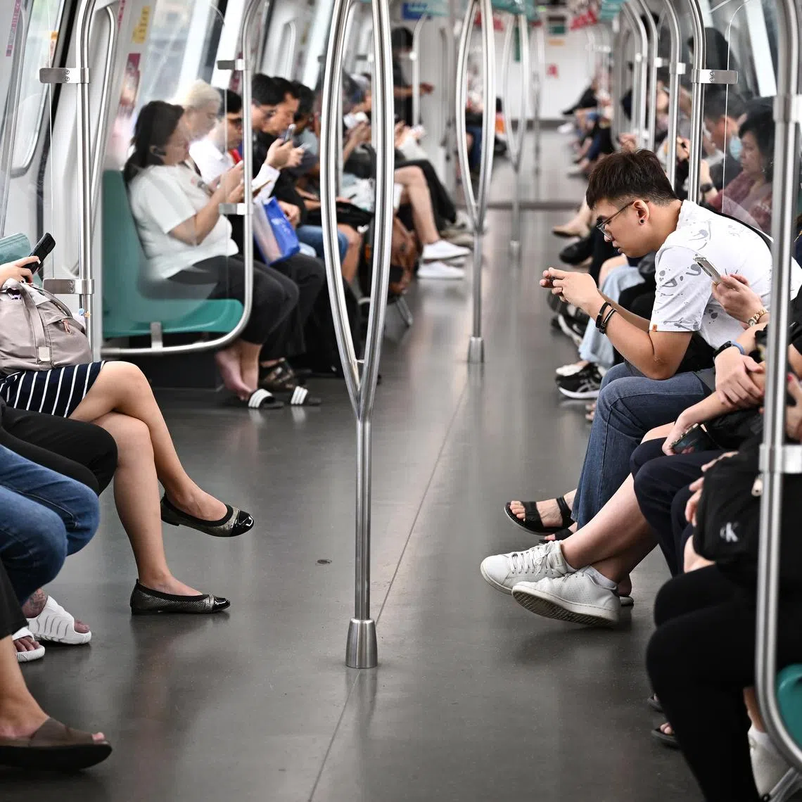 ST20241210-02403200563-Lim Yaohui-pixgeneric/

Generic photograph of passengers using their handphones on the train along the East-West Line (EWL) near Tanah Merah MRT station on Dec 10, 2024. 

Can be used for stories on telecommunications, phone, handphone, Singtel, mobile, M1, Starbub, call, train, transport, fare and signal. 

(ST PHOTO: LIM YAOHUI)