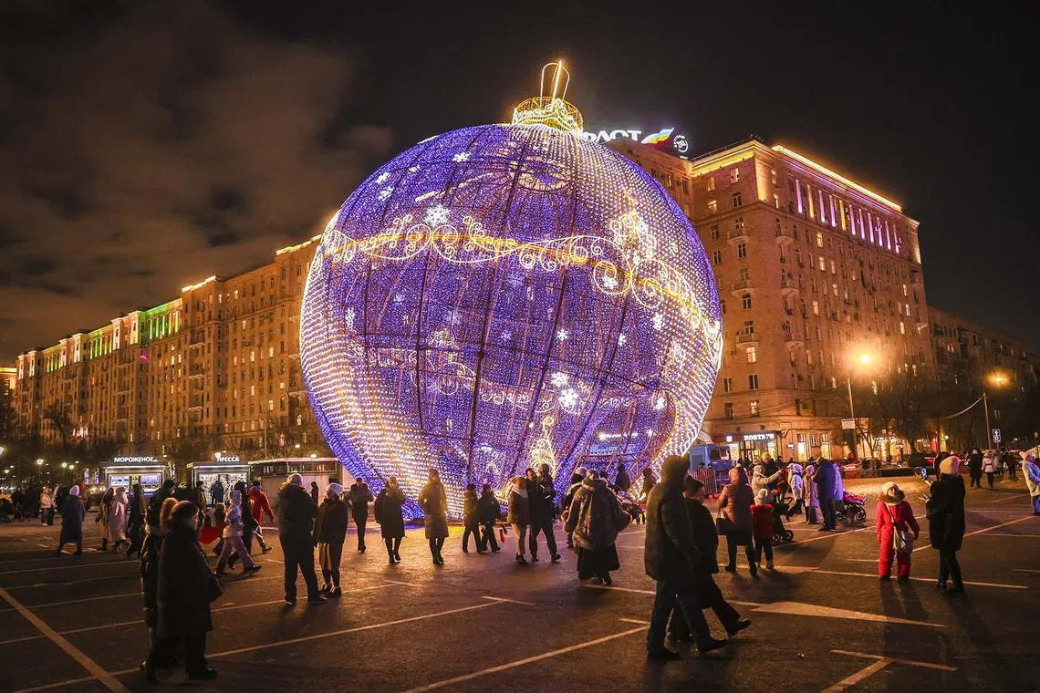 People walking past street decorations for Christmas holidays in Moscow, Russia, Jan 6, 2025. 