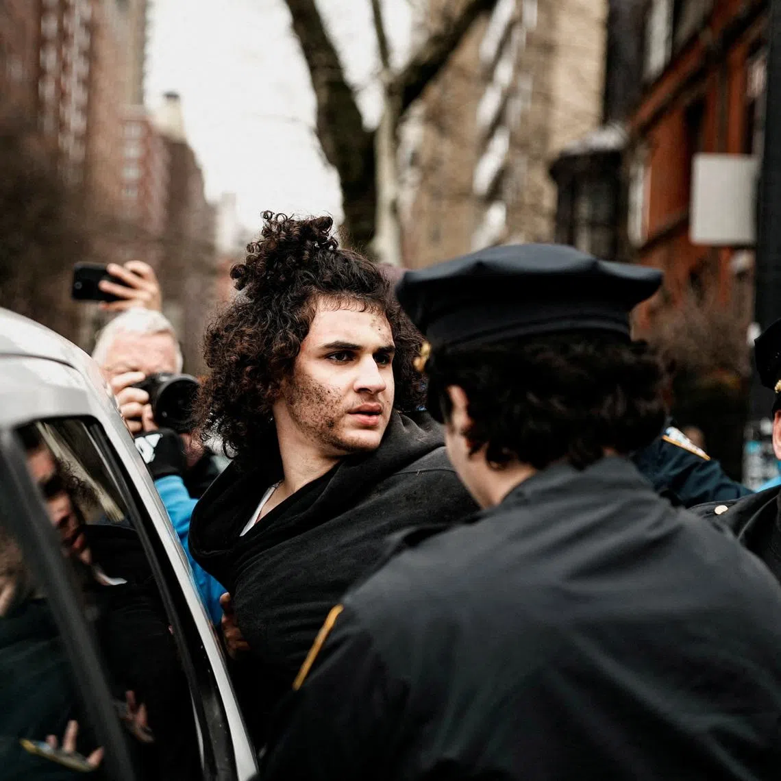 A man identified as Emir Balat is detained by police officers during a rally to stop public Muslim prayer outside the Gracie Mansion official residence of Mayor Zohran Mamdani in New York City, U.S., March 7, 2026. REUTERS/Eduardo Munoz