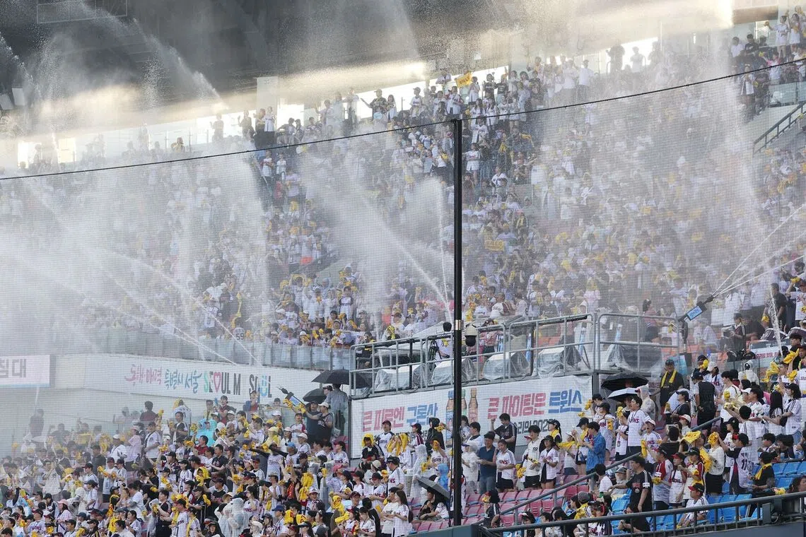 Water cannons are sprayed into the stands to cool off the crowd during a Korean professional baseball game on July 29.