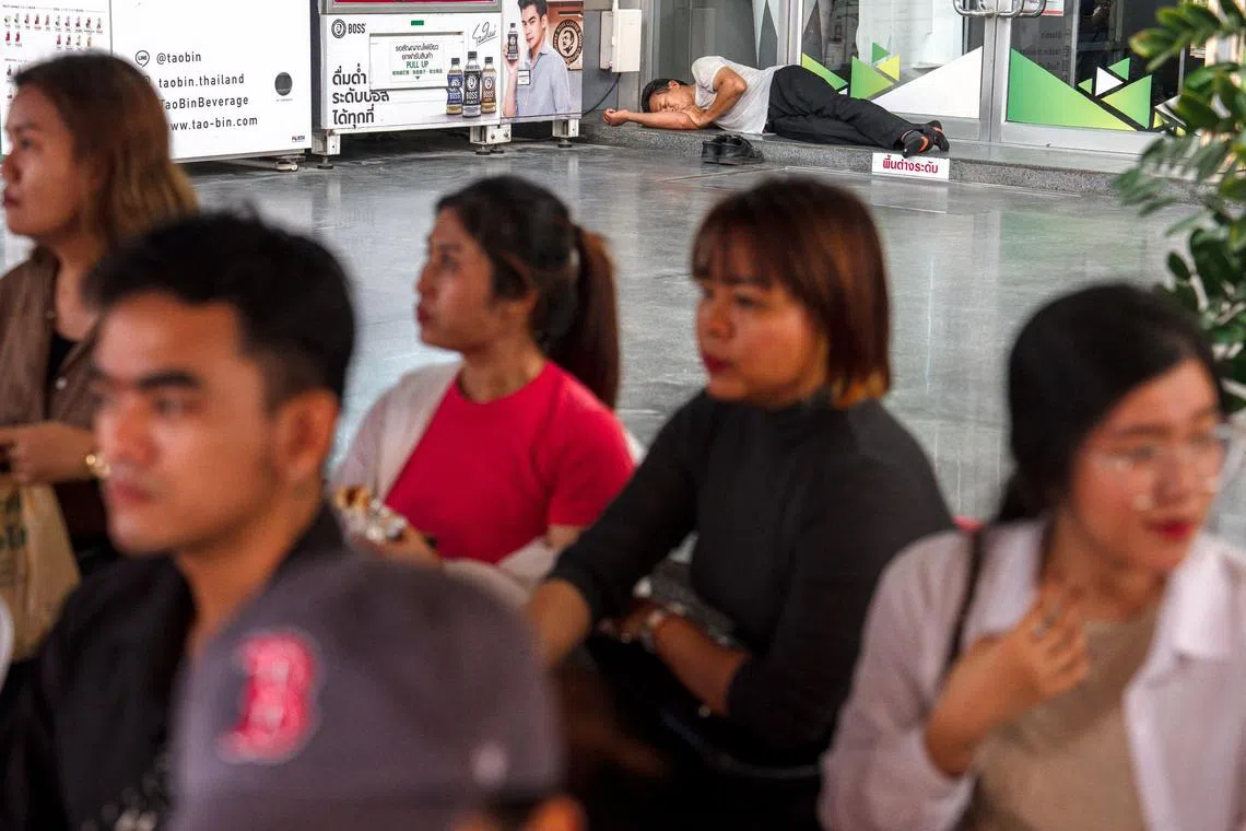 Relatives wait for news of their missing family members, at the site of an under-construction building which collapsed in Bangkok after a massive earthquake in Myanmar.