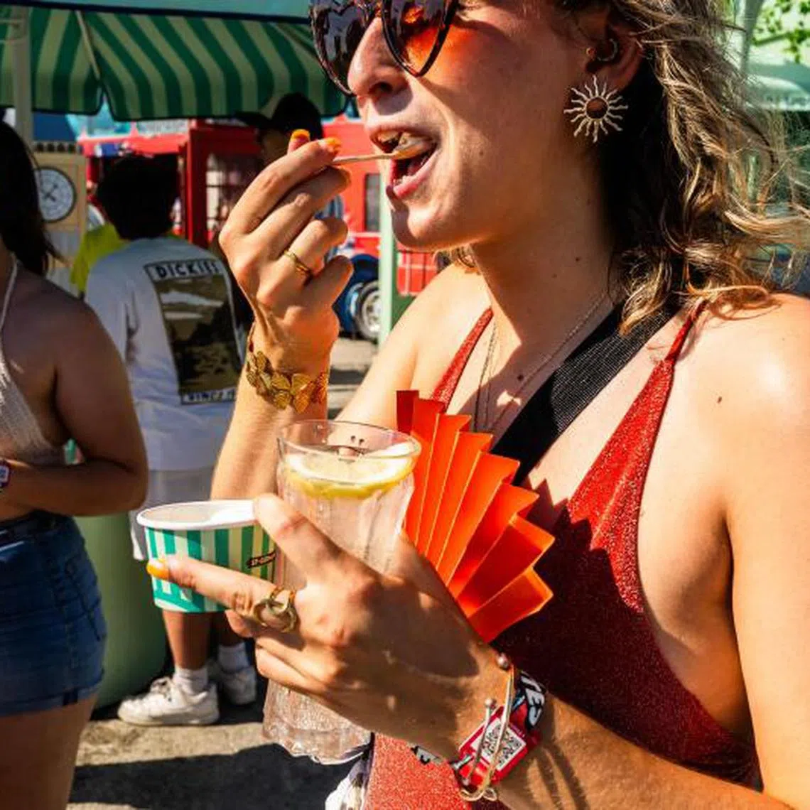 People eating an ice cream at a music festival amidst a heatwave in southern France, on June 29.