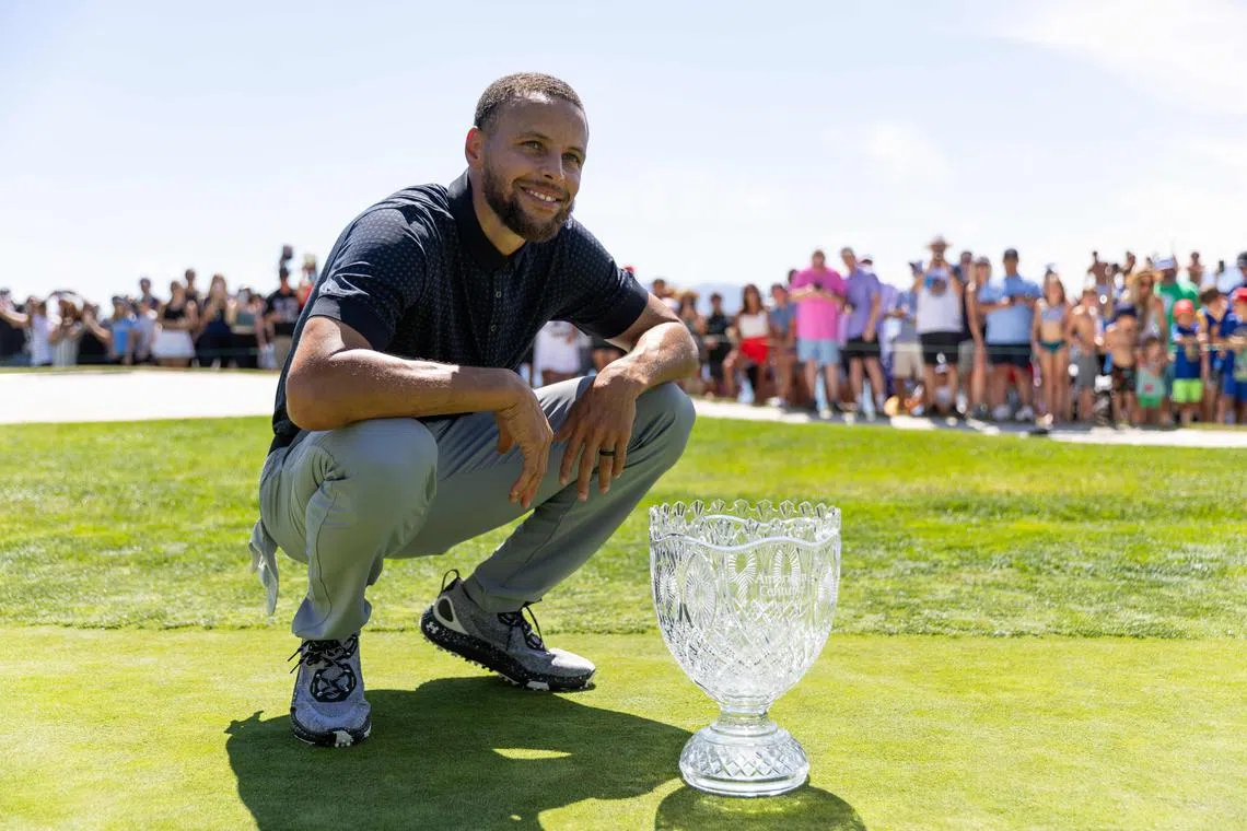NBA star Stephen Curry of the Golden State Warriors with his trophy after winning the American Century Championship in Nevada on July 16, 2023.