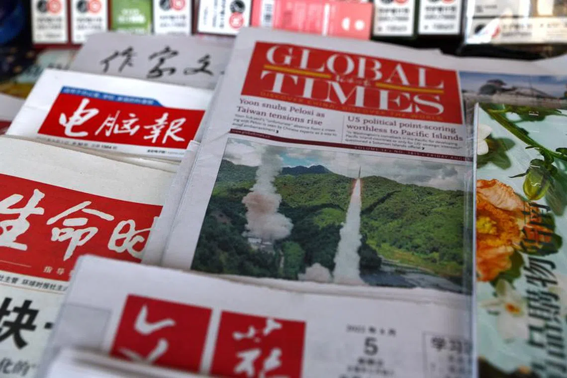 A picture of the Rocket Force under the Eastern Theatre Command of China's People's Liberation Army (PLA) conducting conventional missile tests into the waters off the eastern coast of Taiwan, is seen on a newspaper front-page, at a newsstand in Beijing, China August 5, 2022. REUTERS/Tingshu Wang/File Photo