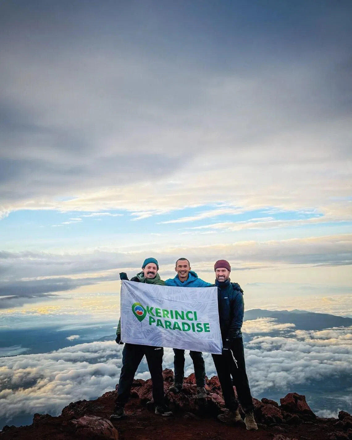 Mr Jetz Herwanto flanked by two foreign climbers at Mount Kerinci.