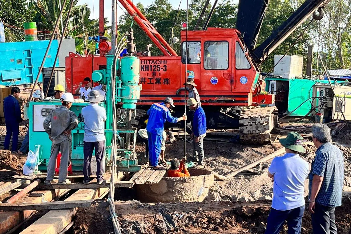 Rescuers went to a depth of 25m to retrieve a 10-year-old Vietnamese boy's body, which was trapped inside a narrow, hollow concrete pillar. 