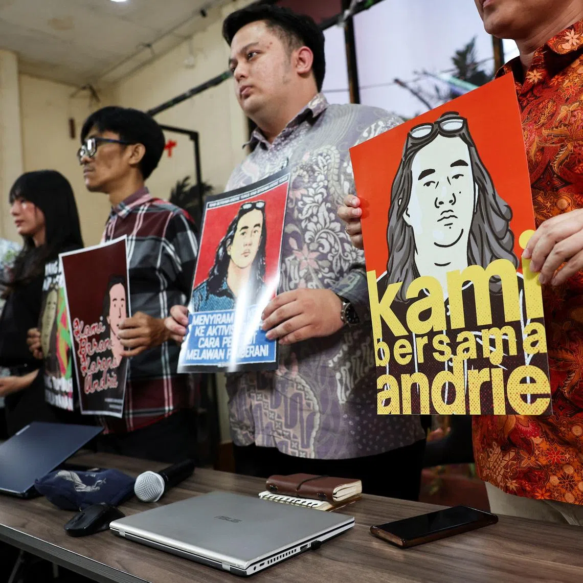 Advocacy for Democracy Team members hold posters in solidarity with activist Andrie Yunus, who suffered burns to his face and arms from an acid attack.