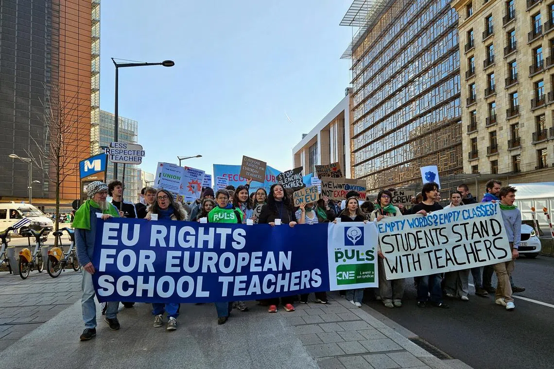 European schoolteachers take part in a protest during an half-day strike outside the EU institutions headquarters in Brussels, Belgium, March 19, 2025.  REUTERS/Tiffany Vermeylen