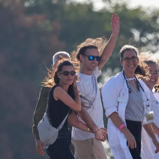 Israeli soldiers and medics accompany Mr Ariel Cunio (second from left) in Ramat Gan, Israel, on Oct 13, 2025, alongside former hostage Arbel Yehud (left) who was released in a previous exchange in January. 