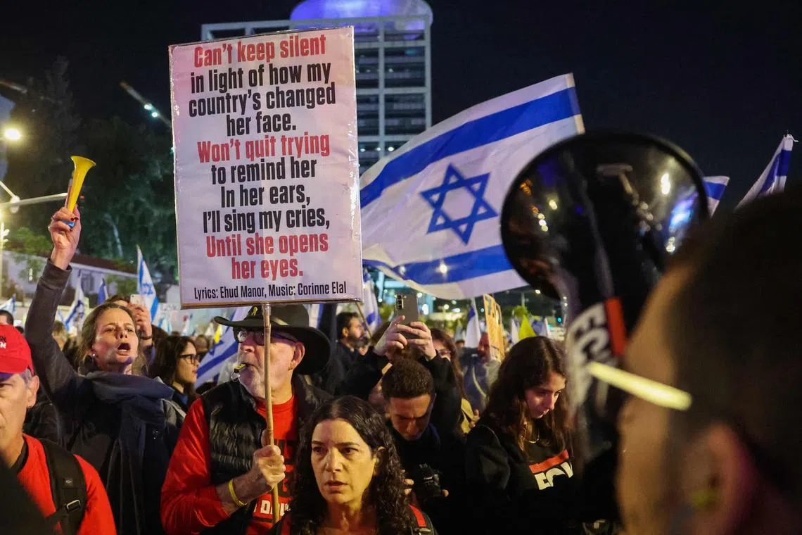 People calling for action to secure the release of Israeli hostages held captive in Gaza since October 2023 protest in front of the Israeli Defence Ministry in Tel Aviv on Dec 14.