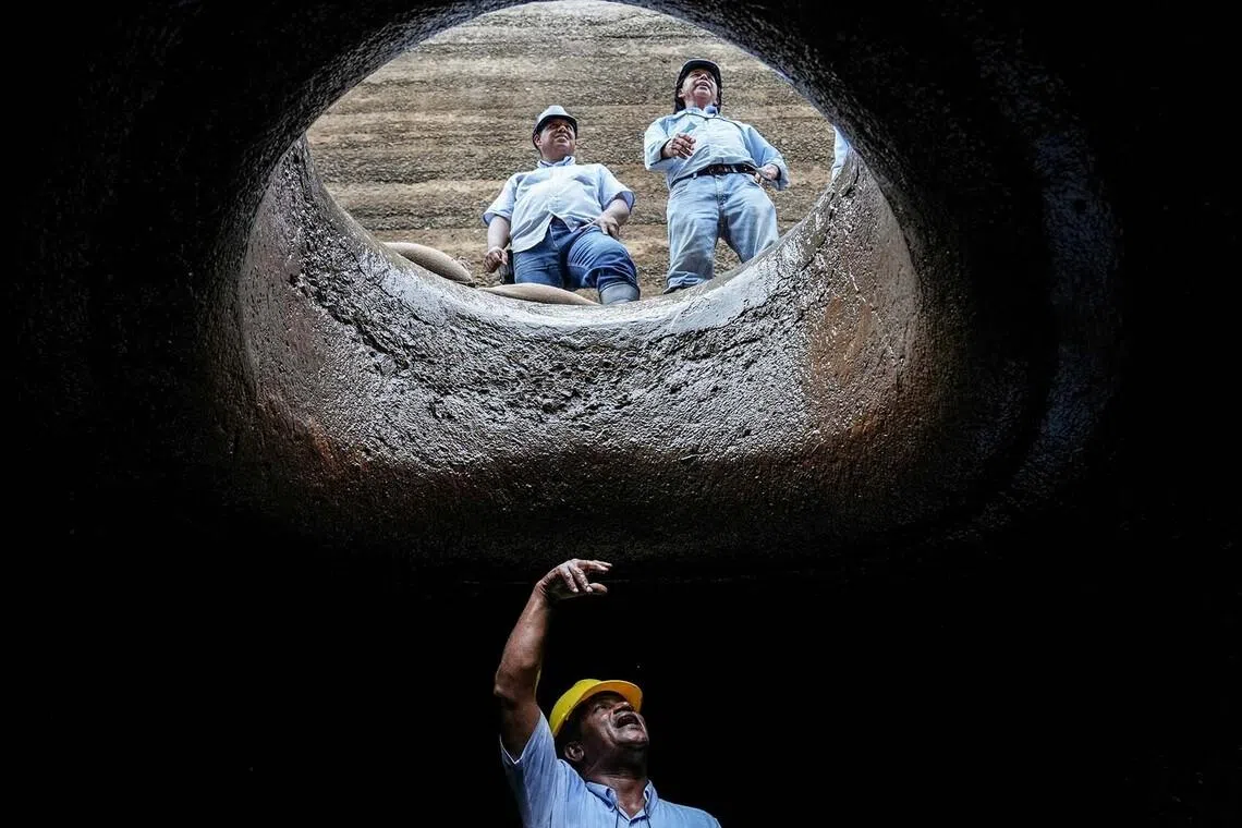 Workers of the Panama Canal Authority carrying out maintenance work inside the tunnels of Gatun Locks during a media visit at the Panama Canal, in Colon, Panama, June 15.