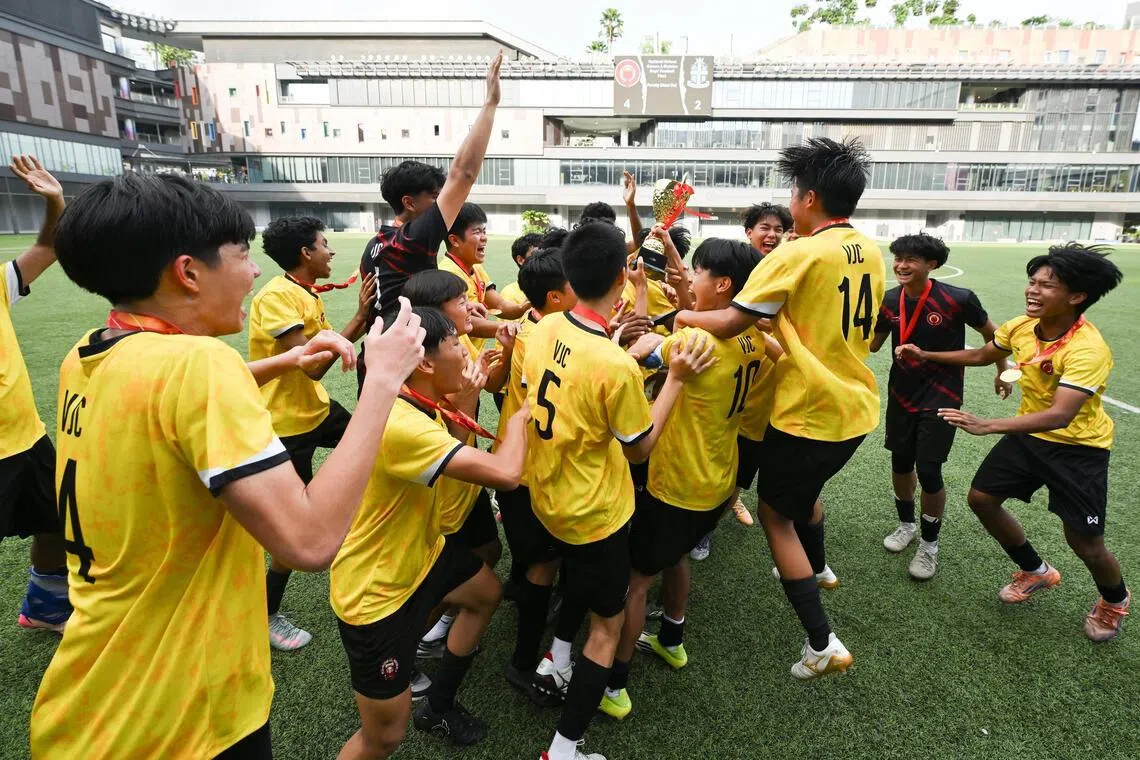 Victoria Junior College players celebrating with their trophy after winning A Division Boys' National School Games (NSG) football finals at Our Tampines Hub on May 21, 2026. 
