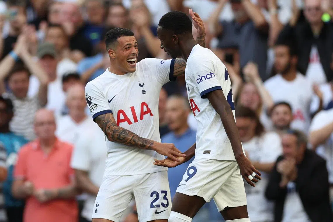 Tottenham Hotspur's Pedro Porro (left) congratulates teammate Pape Matar Sarr after he scored the opening goal.