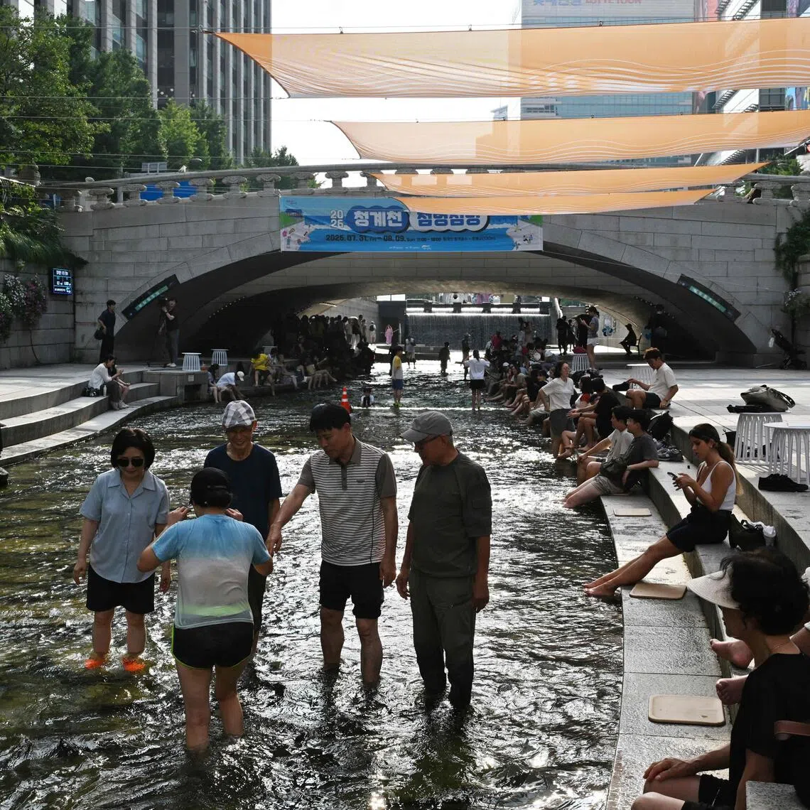 People cooling off in Cheonggyecheon stream in Seoul during a heatwave on Aug 3.