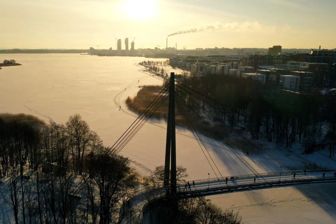 People walk during sunny weather in Helsinki, Finland January 16, 2021. Lehtikuva/Vesa Moilanen via REUTERS