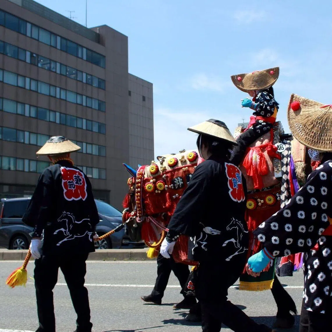 The parade in north-eastern Iwate prefecture saw about 70 horses wearing ornate harnesses parading through rice paddies and city streets.