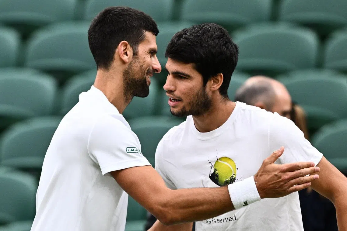 Serbia's Novak Djokovic (left) shaking hands with Spain's Carlos Alcaraz during a practise session before their Wimbledon semi-final tennis matches at The All England Lawn Tennis Club on Friday.