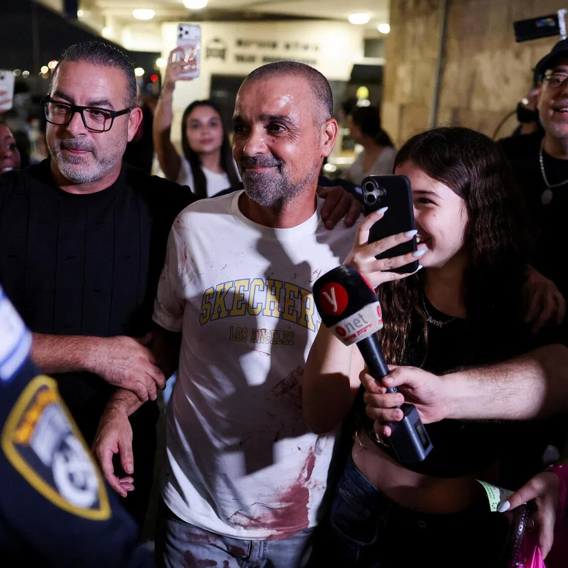 Yaniv Hayun (centre) - one of the passengers who helped incapacitate an attacker on a flydubai flight from the UAE to Israel - returning to Israel on Sept 30.