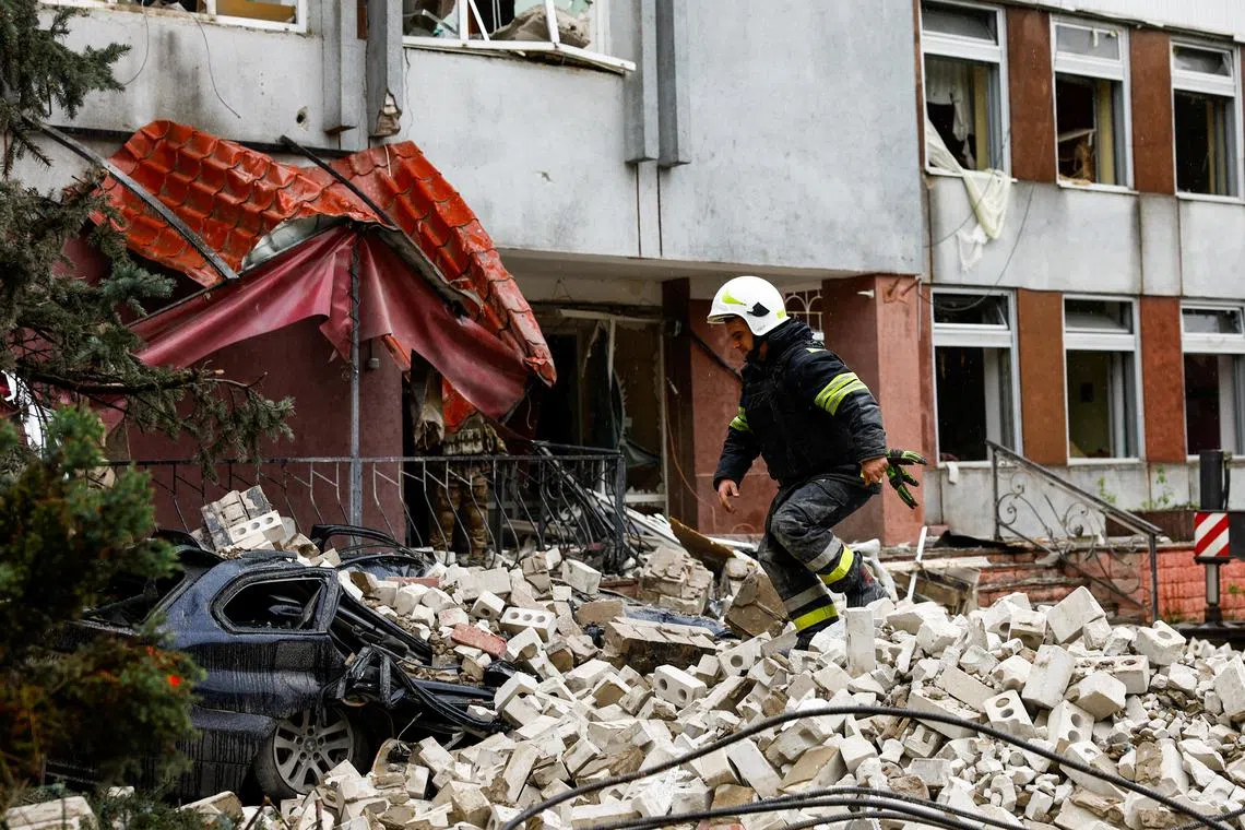 A rescue worker walks on rubble at the site of a destroyed building during a Russian missile strike, amid Russia's attacks on Ukraine, in Chernihiv.