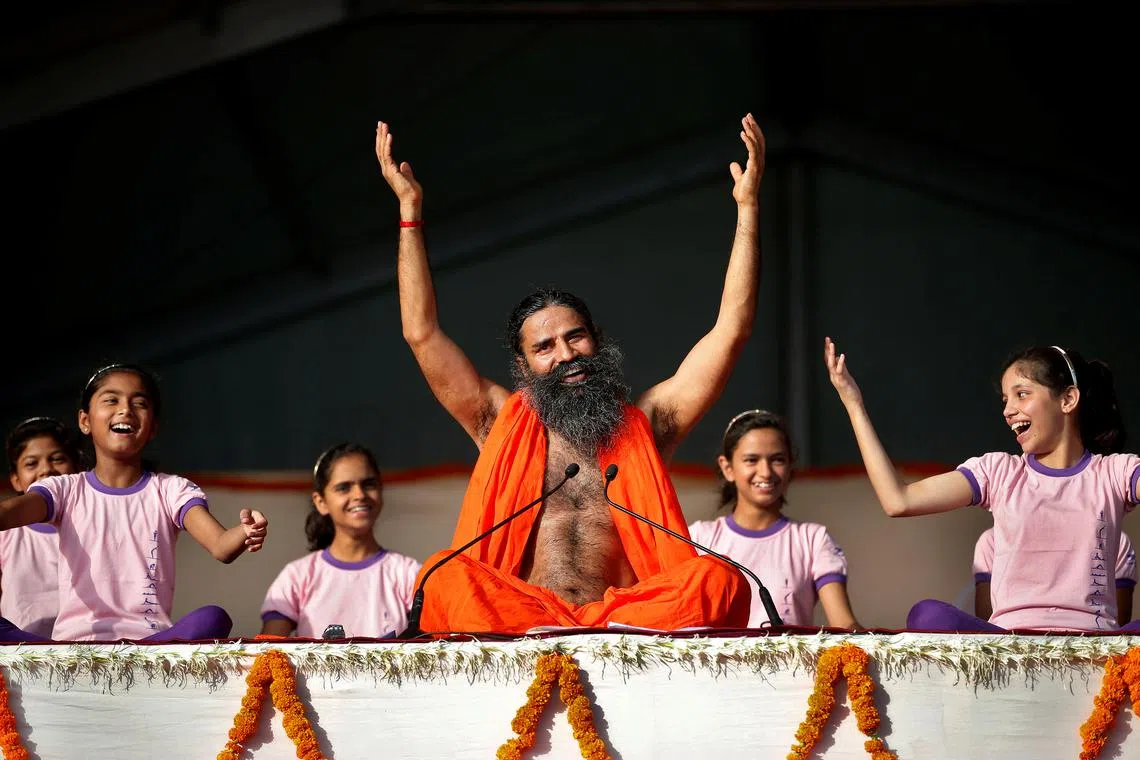 Yoga guru Baba Ramdev performs yoga at a four-day long camp ahead of International Yoga Day in Ahmedabad, India June 18, 2017. REUTERS/Amit Dave/ File photo