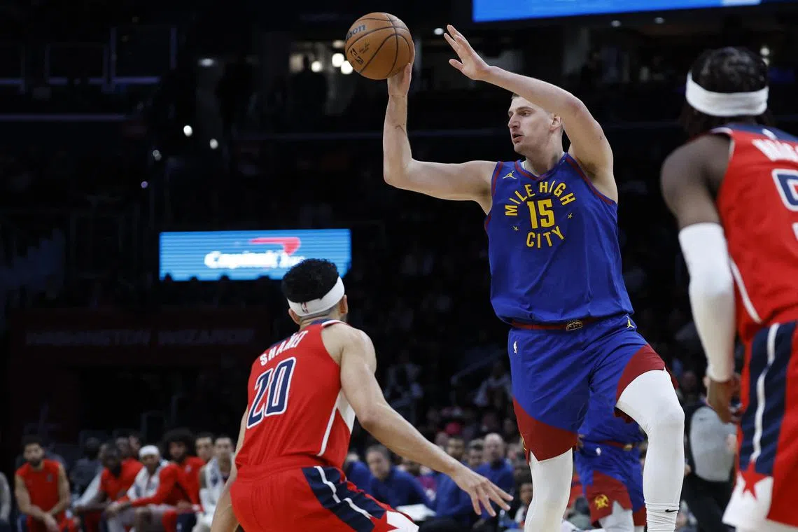 Denver Nuggets centre Nikola Jokic leaping to pass the ball over Washington Wizards guard Landry Shamet in the first half at Capital One Arena. The Serb centre scored 42-points in his team's 113-104 win on Jan 21.