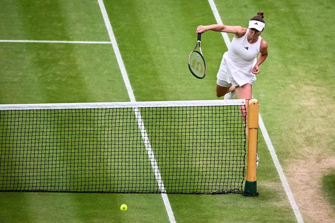 Ukraine's Elina Svitolina returning the ball to Poland's Iga Swiatek during their women's singles quarter-finals tennis match on the ninth day of the 2023 Wimbledon Championships at The All England Tennis Club on Tuesday. The Ukraninian upset the world No. 1 7-5, 6-7 (7-5), 6-2 