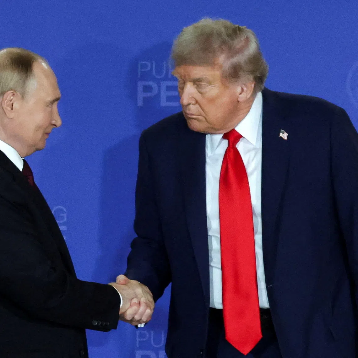 FILE PHOTO: U.S. President Donald Trump and Russian President Vladimir Putin shake hands during a press conference following their meeting to negotiate an end to the war in Ukraine, at Joint Base Elmendorf-Richardson in Anchorage, Alaska, U.S., August 15, 2025. REUTERS/Jeenah Moon/File Photo