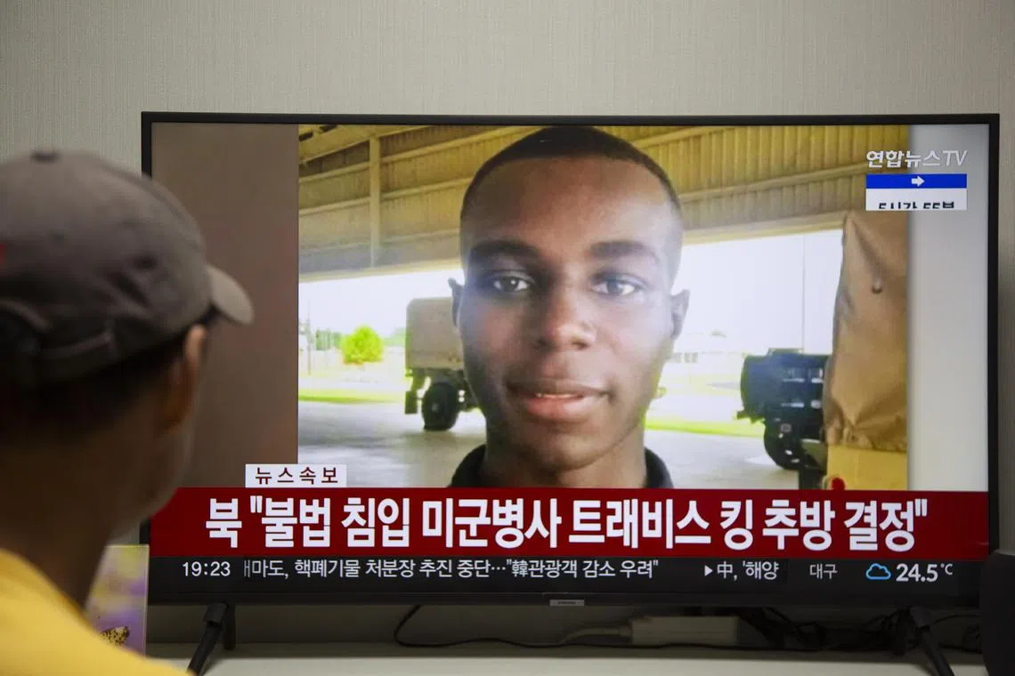 A man watches the news showing US soldier Travis King on screen, at his home in Seoul, South Korea.