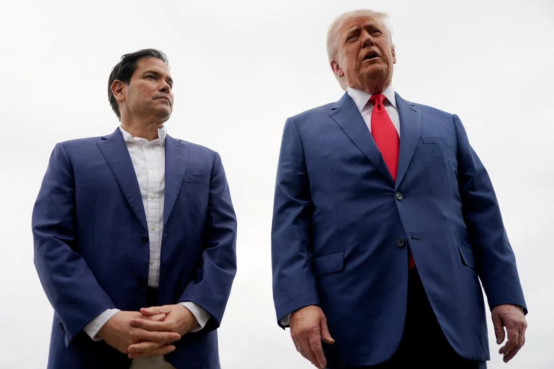 FILE PHOTO: U.S. President Donald Trump stands with U.S. Secretary of State Marco Rubio as he prepares to depart for Hagerstown, Maryland, at Morristown Municipal Airport in Morristown, New Jersey, U.S., June 8, 2025. REUTERS/Nathan Howard/File Photo