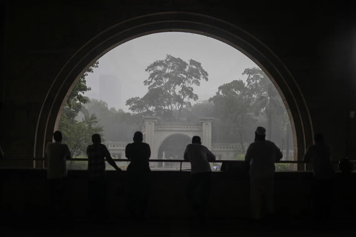 People inside a building during rainfall in Dhaka, Bangladesh, on July 15, 2025. The Bangladesh Meteorological Department (BMD) has forecasted thunderstorms across all divisions, including Dhaka. 