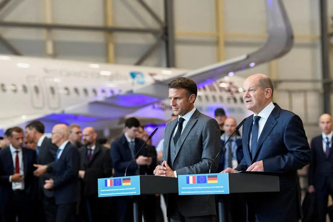 German Chancellor Olaf Scholz and French President Emmanuel Macron address the media at the Airbus plant in Hamburg, Germany, October 9, 2023. REUTERS/Fabian Bimmer