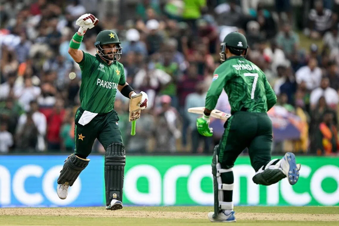 Pakistan's Sahibzada Farhan (left) celebrates with Shadab Khan after scoring a century in the ICC Men's T20 Cricket World Cup group-stage match against Namibia at the Sinhalese Sports Club Ground in Colombo on Feb 18, 2026.