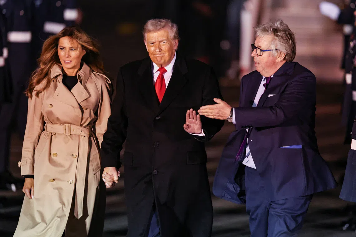 US President Donald Trump (centre) and First Lady Melania Trump (left) arriving for their state visit to Britain, at London Stansted Airport on Sept 16.