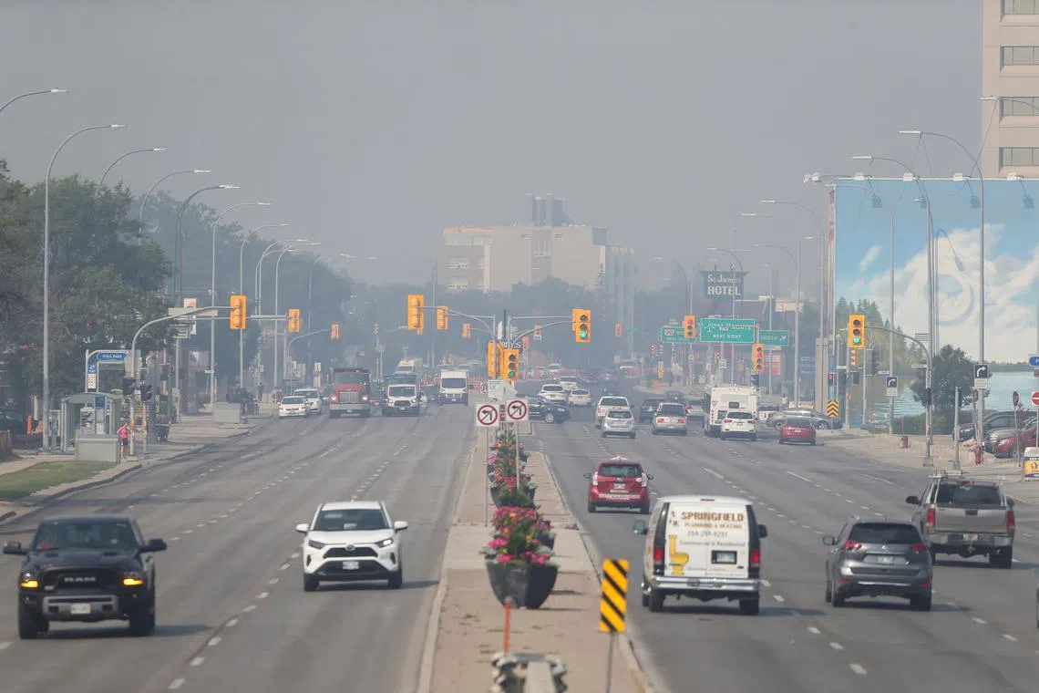 FILE PHOTO: Haze from wildfires covers Portage Avenue in Winnipeg, Manitoba, Canada, July 29, 2021. REUTERS/Shannon VanRaes/File Photo