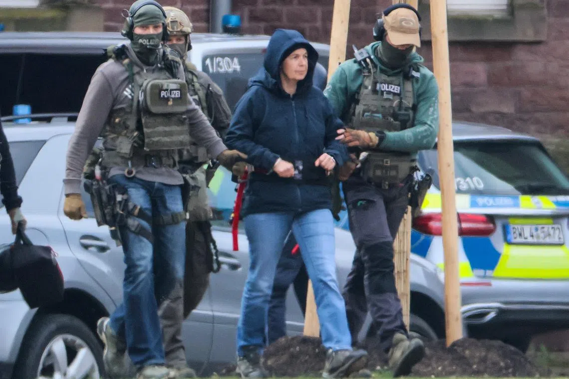 FILE PHOTO: Daniela Klette, a 65-year-old member of Germany's notorious Red Army Faction (RAF) militant group, who has been arrested after decades on the run for armed robbery and attempted murder is brought to a helicopter, on the day of her appearance before German Federal Public Prosecutor, in Karlsruhe, Germany March 7, 2024. REUTERS/Wolfgang Rattay/File Photo