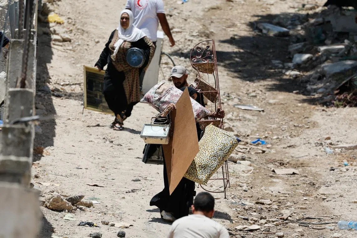 Palestinians remove belongings from their homes threatened with demolition, during the ongoing Israeli military operation in Tulkarm camp, in the Israeli-occupied West Bank, July 2, 2025. REUTERS/Raneen Sawafta/File Photo