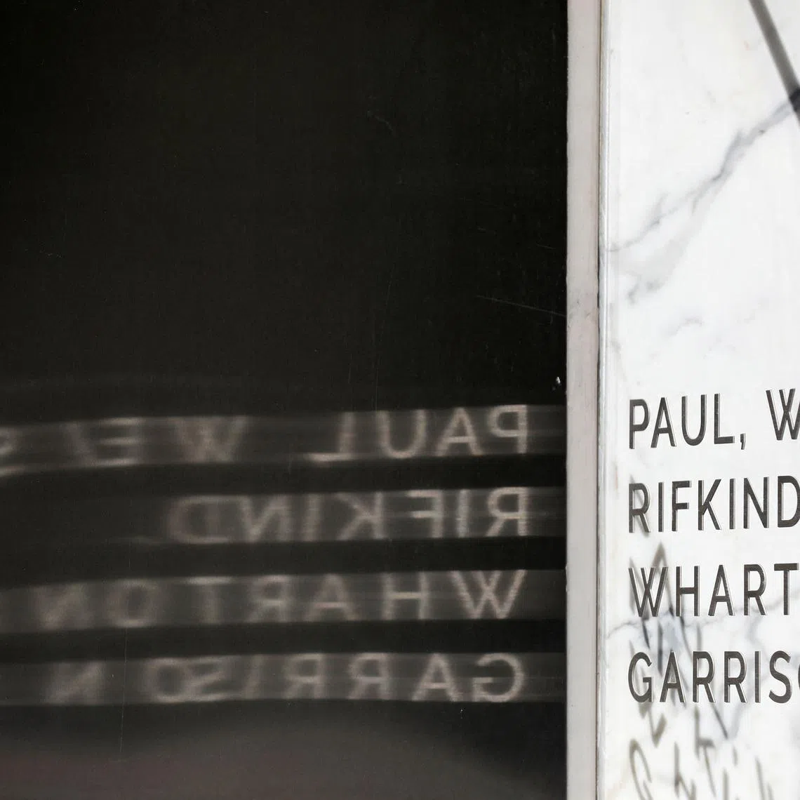 FILE PHOTO: Signage is seen outside of the law firm Paul, Weiss, Rifkind, Wharton & Garrison LLP in Washington, D.C., U.S., August 30, 2020. REUTERS/Andrew Kelly/File Photo
