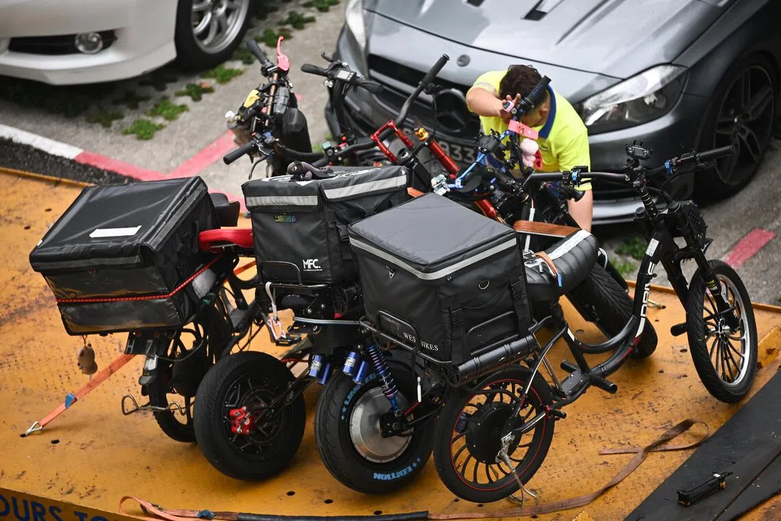 Non-compliant active mobility devices confiscated by LTA being loaded onto a tow truck in Yishun on Nov 20.