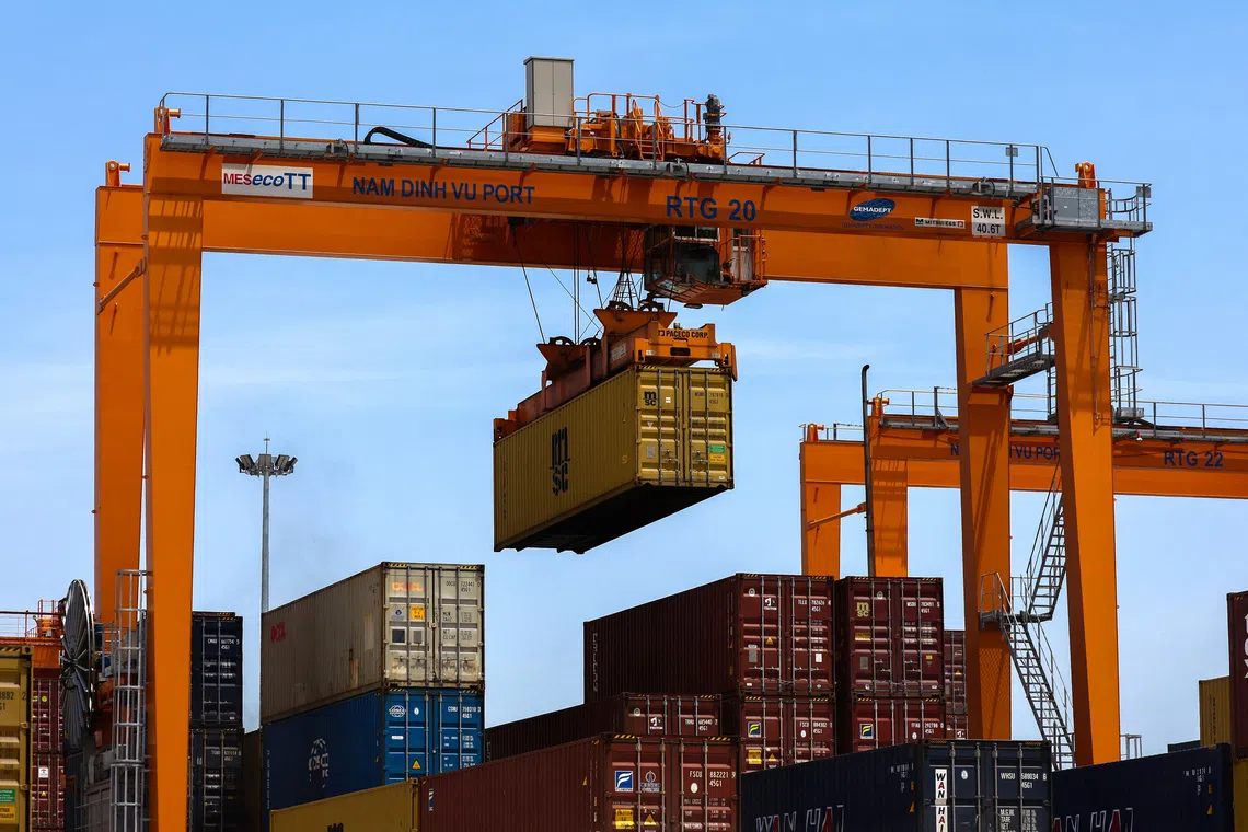 FILE PHOTO: A container is loaded onto a cargo ship while docked at Hai Phong port, in Hai Phong, Vietnam, April 16, 2025. REUTERS/Athit Perawongmetha/File Photo