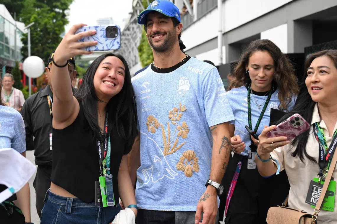 RB's Daniel Ricciardo posing for a wefie with a fan ahead of practice at the Sept 20-22 Singapore Grand Prix.