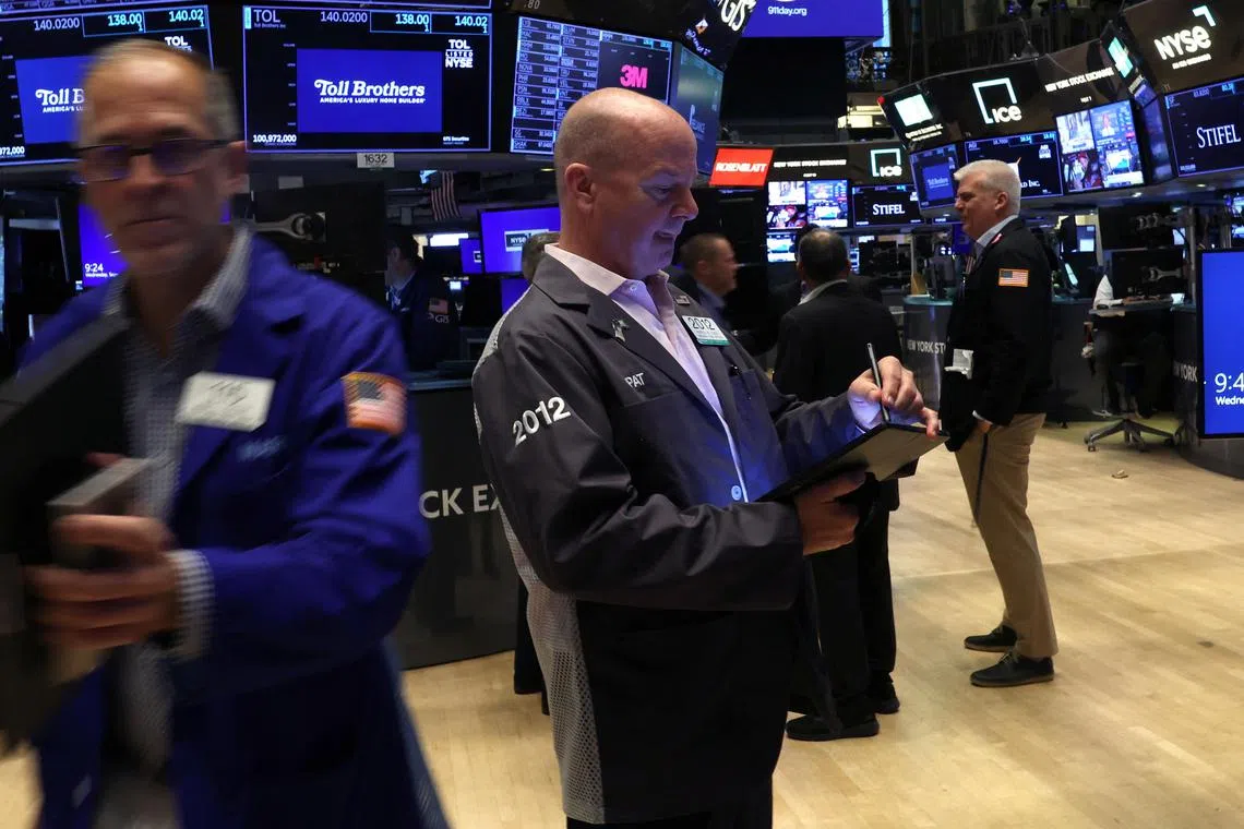 Traders work on the floor of the New York Stock Exchange, in New York City.