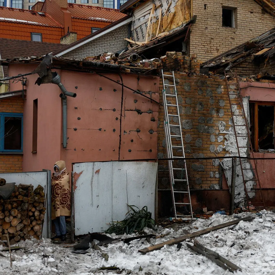 A resident walks next to her grandparents' house damaged during Russian drone and missile strikes, amid Russia's attack on Ukraine, in Kyiv, Ukraine February 26, 2026. REUTERS/Valentyn Ogirenko