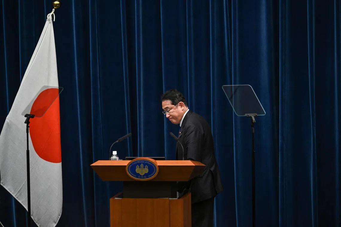 Japan's Prime Minister Fumio Kishida steps off the rostrum after a press conference at the Prime Minister's Office in Tokyo on August 14, 2024.