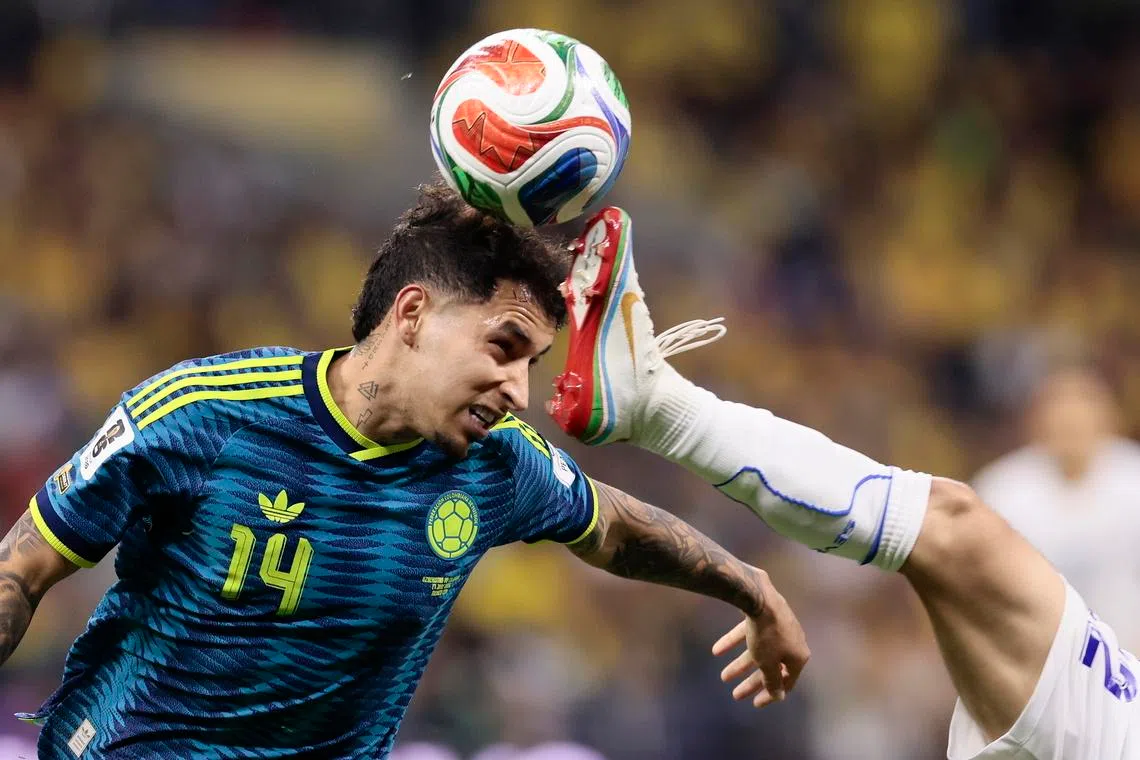 Abbosbek Fayzullaev (right) of Uzbekistan vies for the ball with Gustavo Puerta (left) of Colombia during the 2026 FIFA World Cup match between Uzbekistan and Colombia, at Azteca Stadium in Mexico City, Mexico, June 17, 2026. 