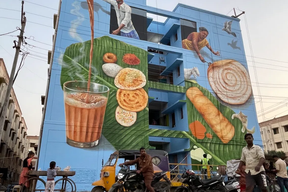 Measuring 15m by 14m, the mural features images of daily life, such as a tea seller pouring tea, a woman making the rice and lentil pancakes thosai, among other things.