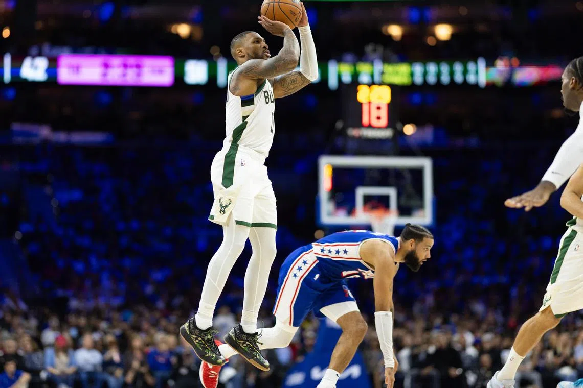 Milwaukee Bucks guard Damian Lillard shoots over Philadelphia 76ers forward Caleb Martin during the second quarter at Wells Fargo Centre.