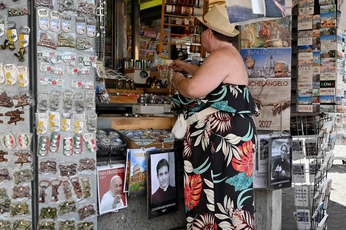 Calendars displaying photos of models dressed as priests on sale in a souvenir shop in Rome on May 18. Mr Giovanni Galizia, who was photographed for the calendar, said he was never a priest.